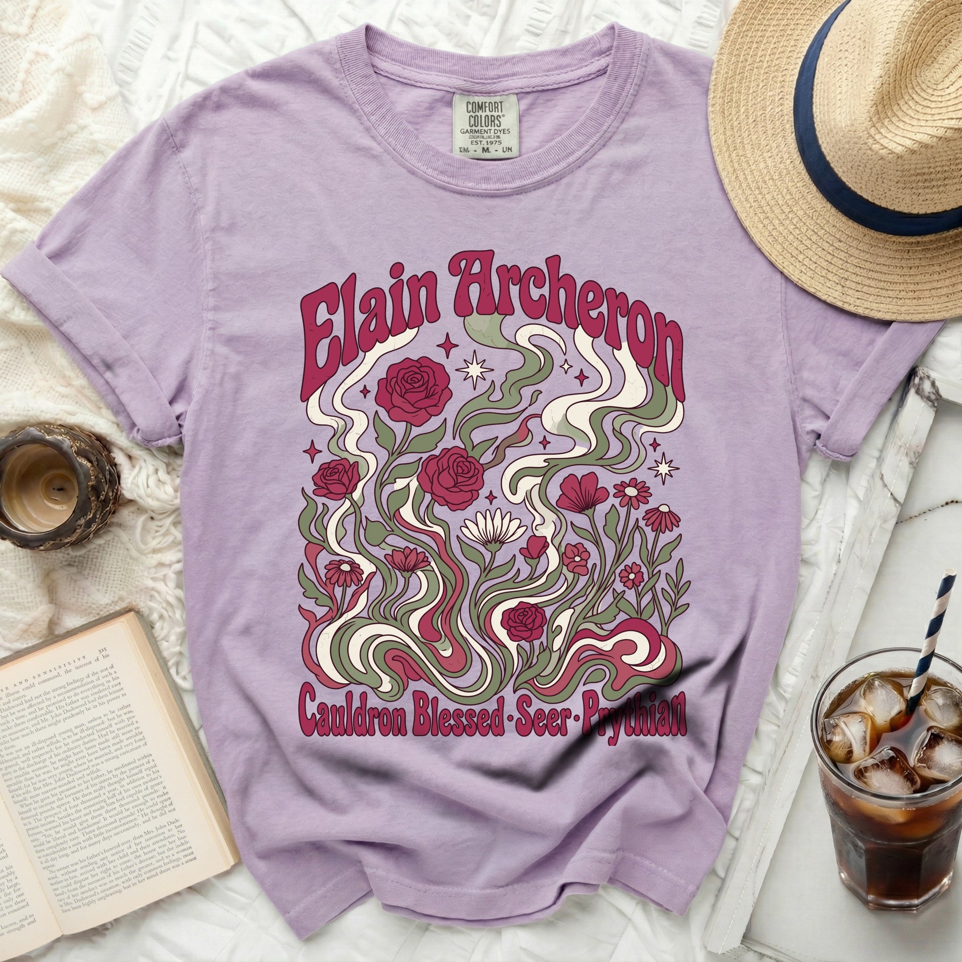 Lilac t-shirt with "Elain Archeron Cauldron Blessed Seer Prythian" floral design.