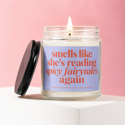 Candle with text "smells like she's reading spicy fairytales again" on a lilac label.