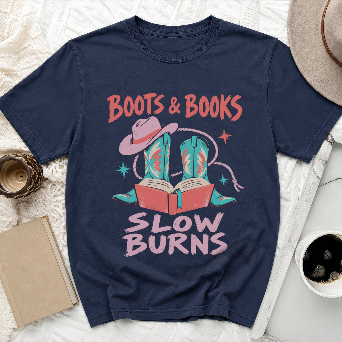Navy t-shirt with "BOOTS & BOOKS SLOW BURNS" text and cowboy boot graphic.