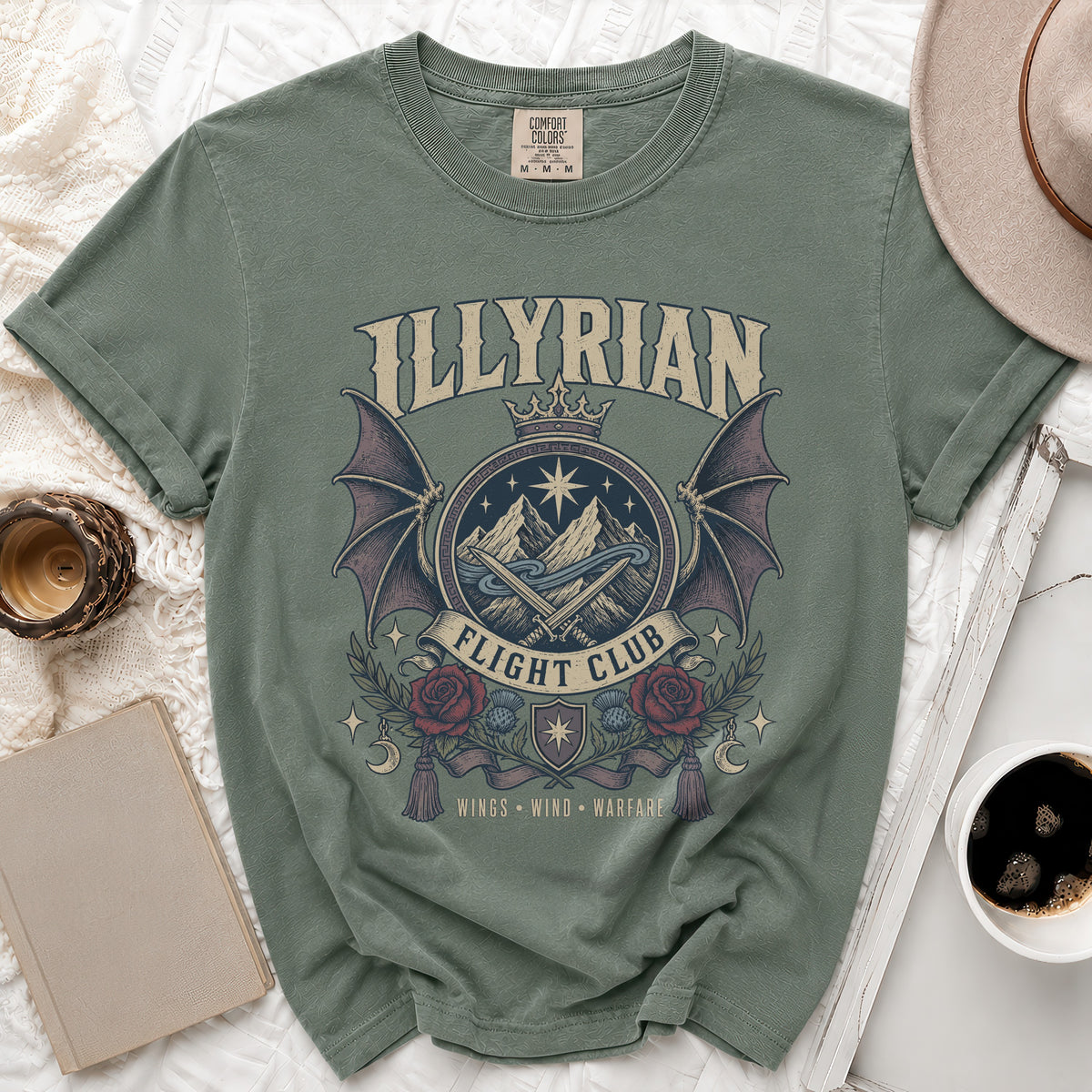 Green t-shirt with "Illyrian Flight Club" graphic featuring mountains, wings, and roses.