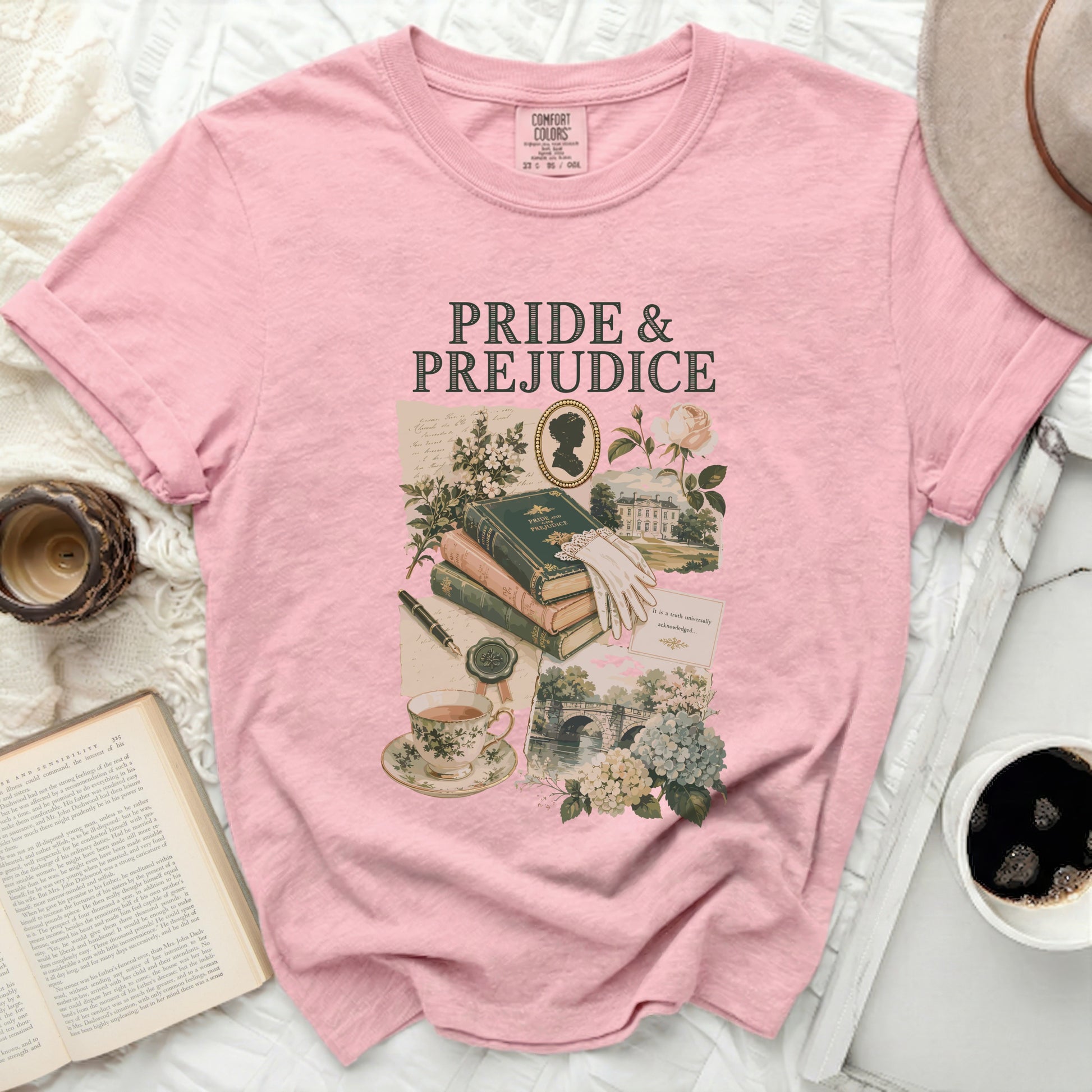 Pink t-shirt with Pride and Prejudice graphic featuring book, teacup, silhouette, and scenery.