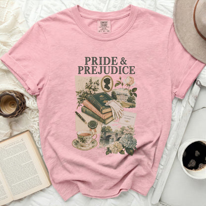 Pink t-shirt with Pride and Prejudice graphic featuring book, teacup, silhouette, and scenery.