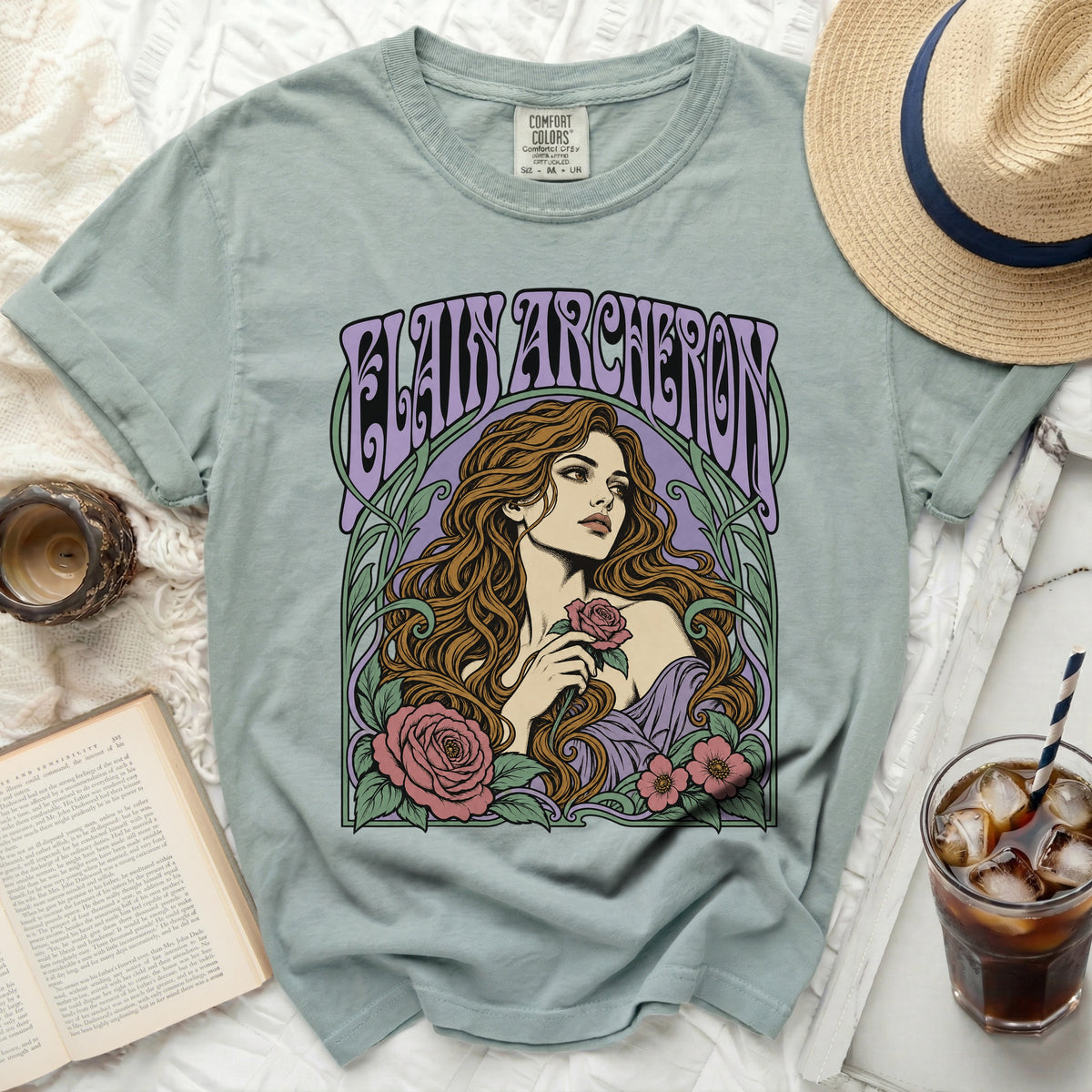 Light green t-shirt with "ELAINE ARCHERON" text and floral art of a woman holding a rose.