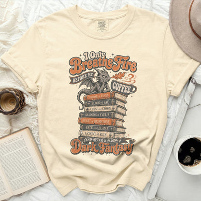 T-shirt with "I Only Breathe Fire Before My Coffee" and Dark Fantasy book titles.