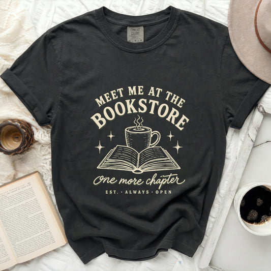 Dark t-shirt with "Meet me at the Bookstore" text and open book.