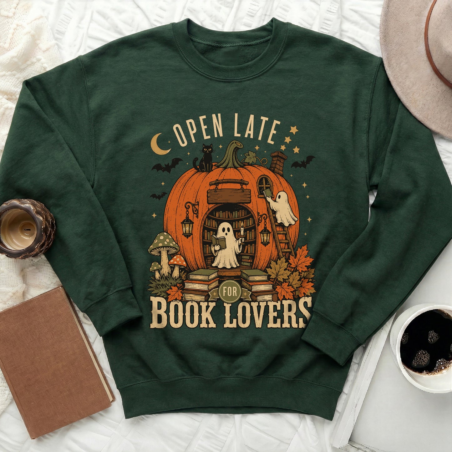 Green sweatshirt with "Open Late For Book Lovers" pumpkin and ghost graphic.