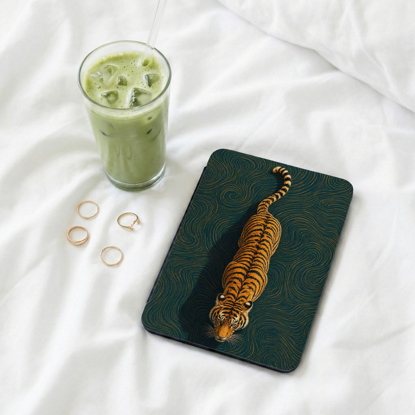 Dark teal device case with a golden tiger and swirling pattern.