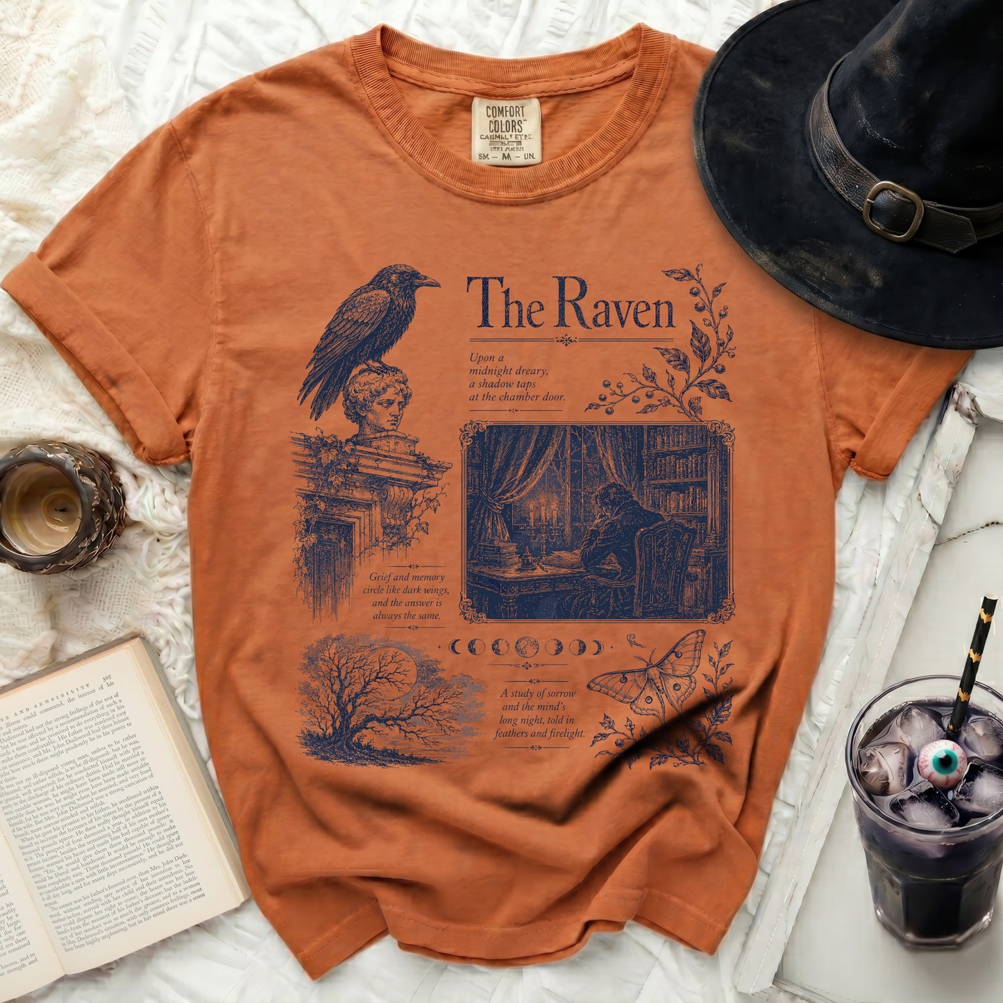 Orange t-shirt with dark blue "The Raven" design featuring a raven, text, and artwork.