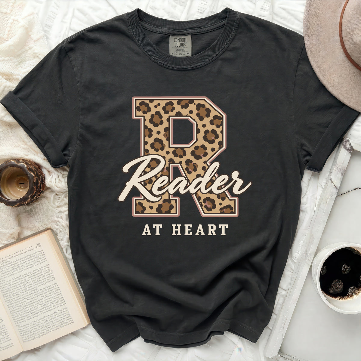 Black Comfort Colors t-shirt with leopard print "R" and "Reader AT HEART" text.