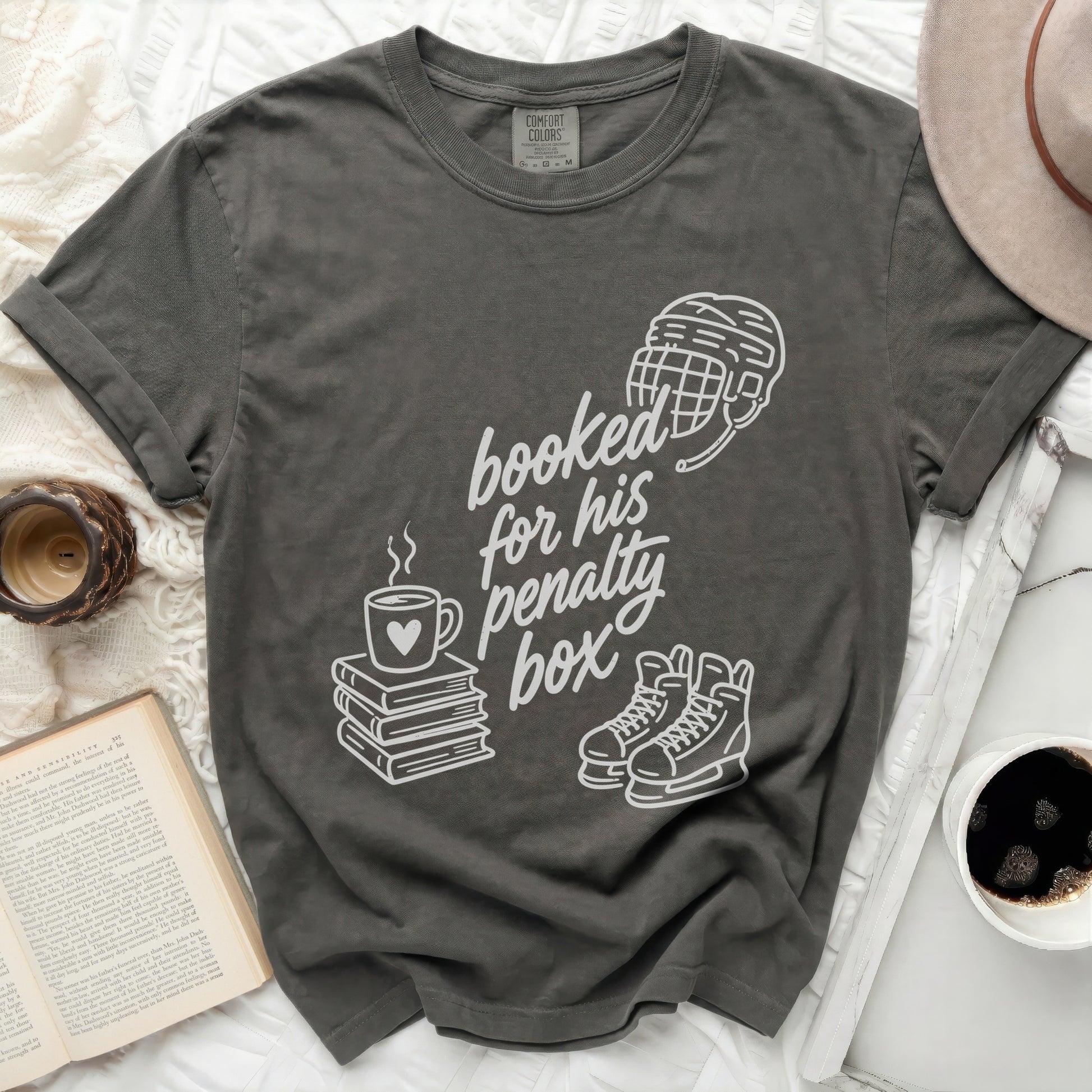 Dark gray t-shirt with "booked for his penalty box" text and hockey imagery.