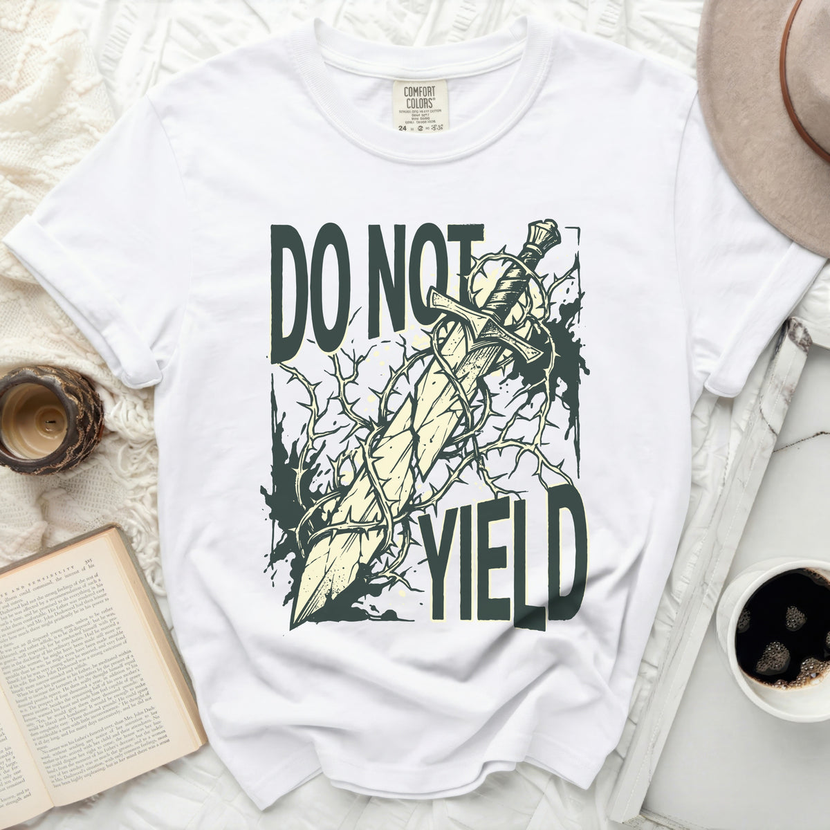 White t-shirt with "DO NOT YIELD" and a sword tangled in thorns.