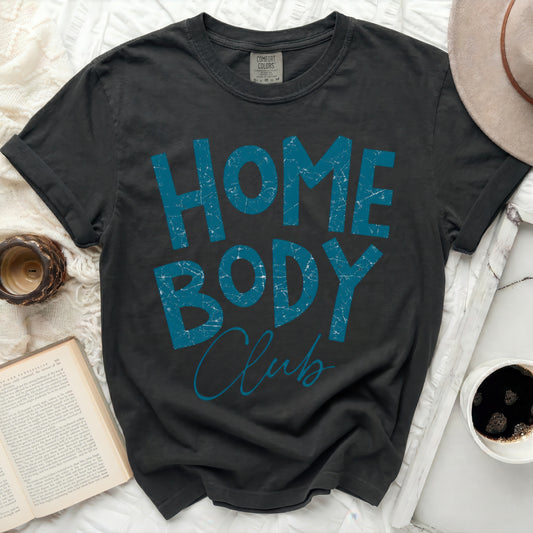 Dark t-shirt with "HOME BODY Club" in distressed blue lettering.