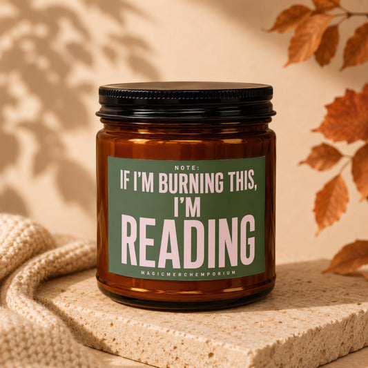 Brown glass candle with green label reading "If I'm burning this, I'm reading."