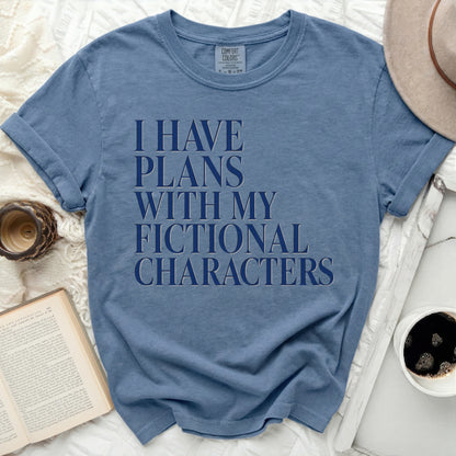 Blue t-shirt with "I HAVE PLANS WITH MY FICTIONAL CHARACTERS" text.
