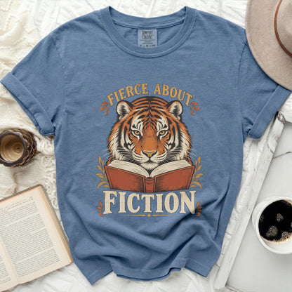 Blue t-shirt with a tiger reading a book and the text "Fierce About Fiction".