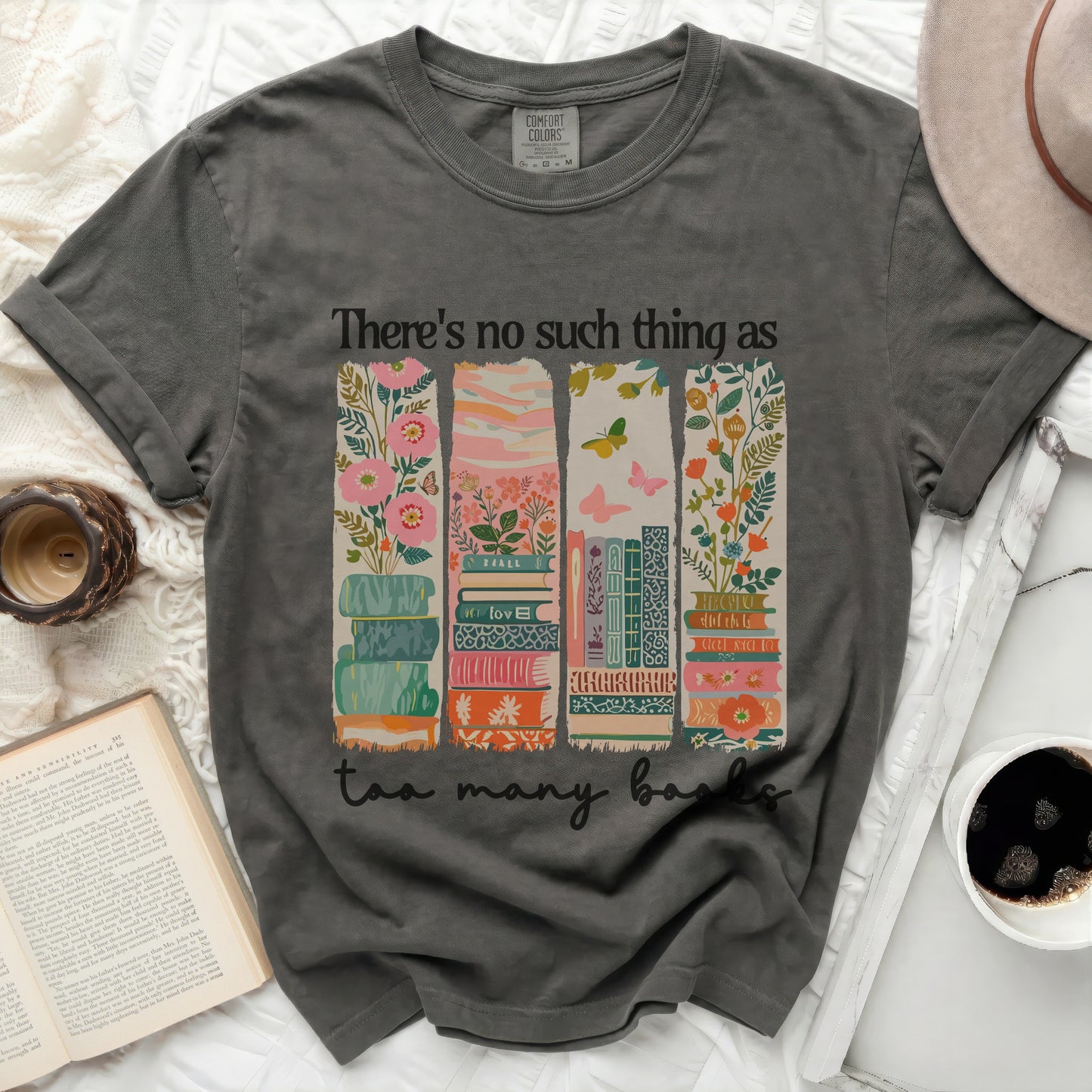 Dark gray t-shirt with "There's no such thing as too many books" and stacked books graphic.