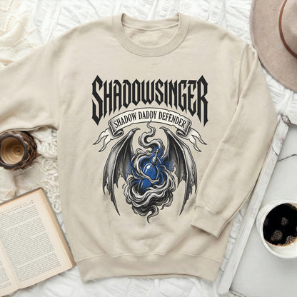 Cream sweatshirt with "SHADOWSINGER SHADOW DADDY DEFENDER" text and bat wings.