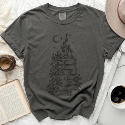 Charcoal gray t-shirt featuring a black line art graphic of a castle atop a stack of books with climbing roses.