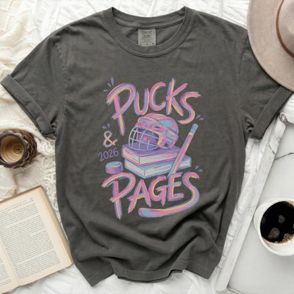 T-shirt with "Pucks & 2026 Pages" text and hockey graphics.