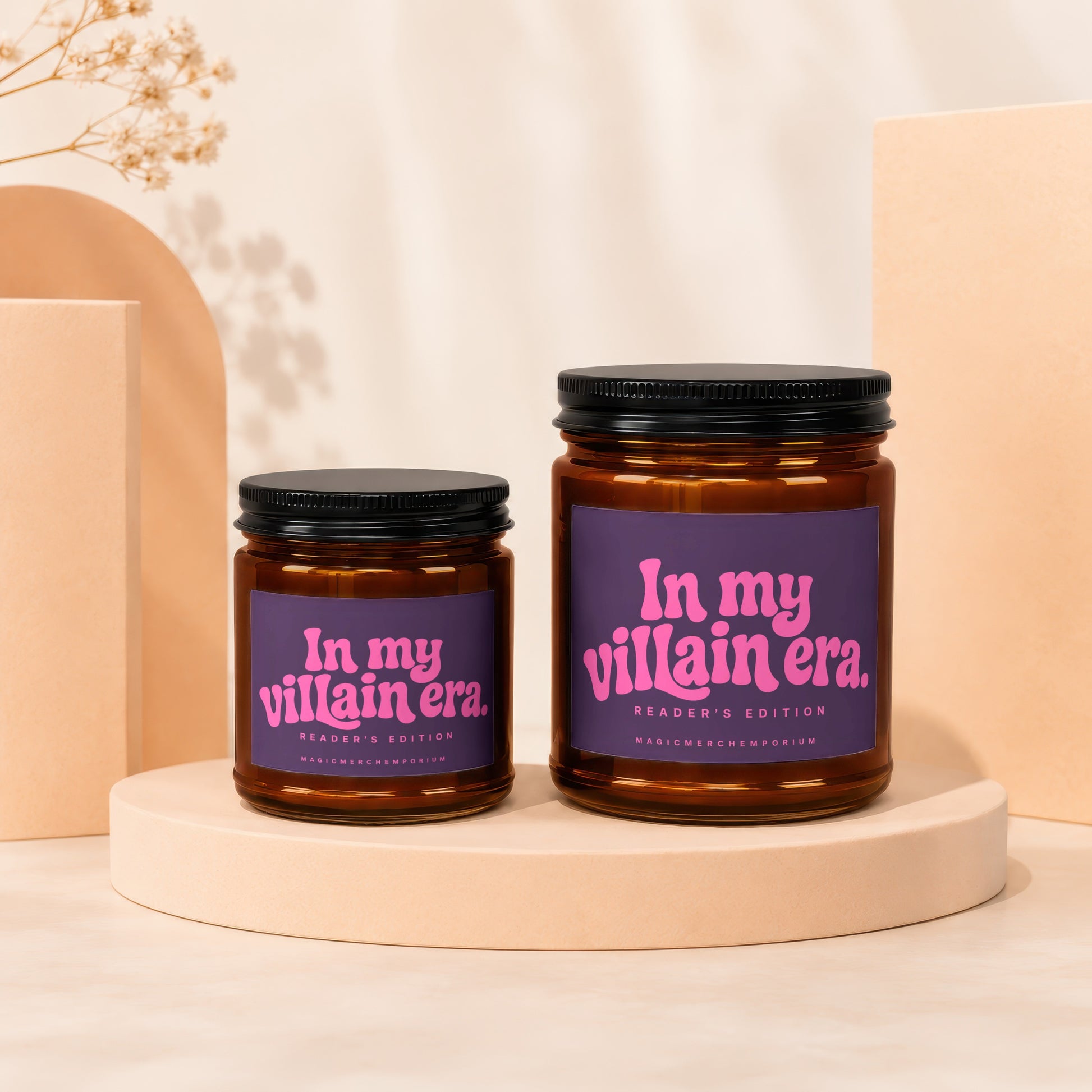 Two amber glass candles with purple labels reading "In my villain era."