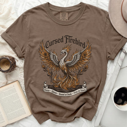 Brown t-shirt with a graphic of a Cursed Firebird, "Vassa - Queen - Bound at Dusk - Free at Dawn".