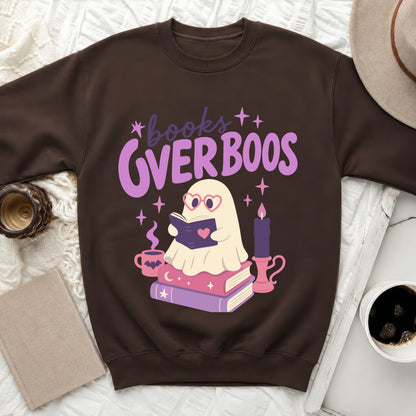 Brown sweatshirt with "books over boos" graphic featuring a reading ghost