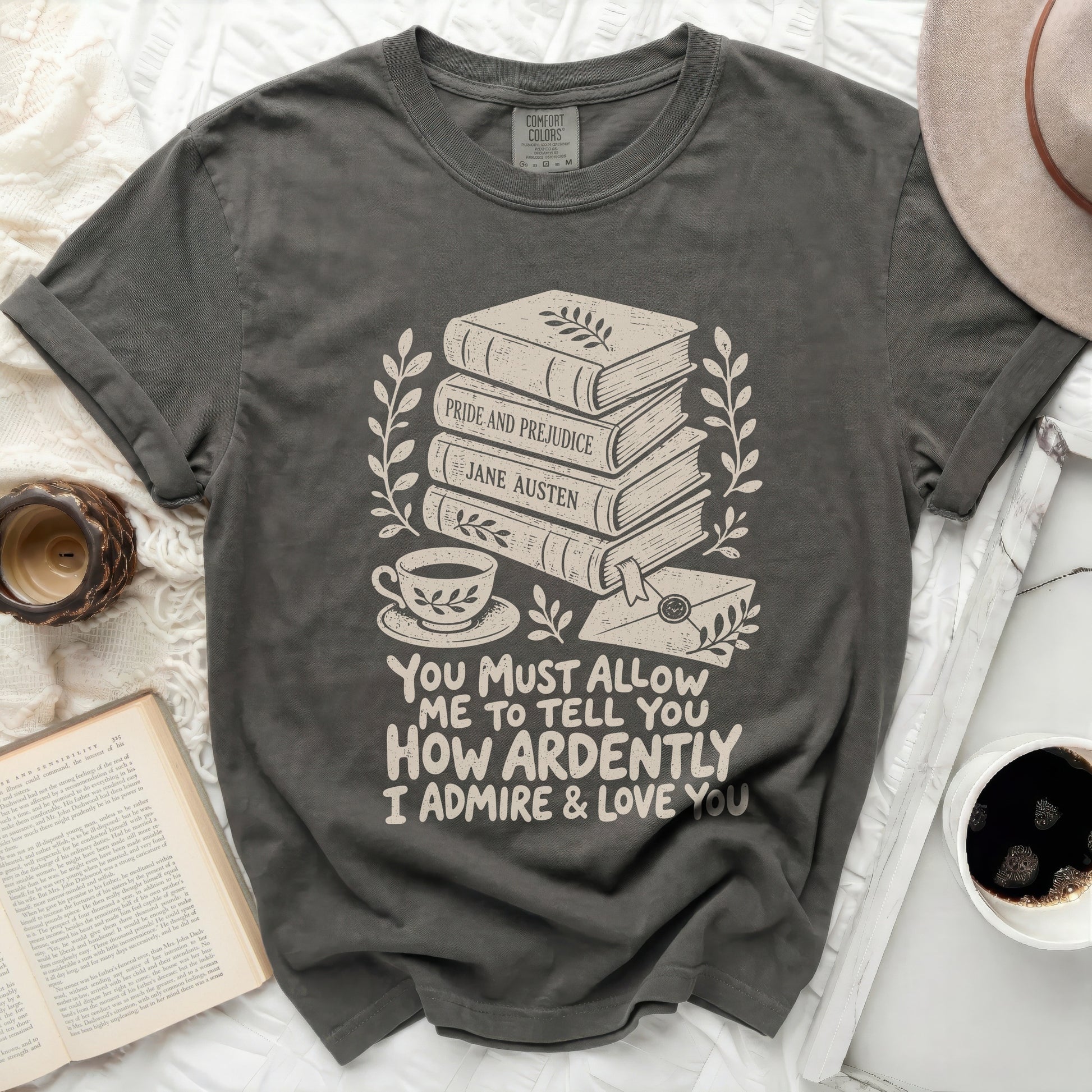 Dark grey t-shirt with stacked books, teacup, and quote about admiration.