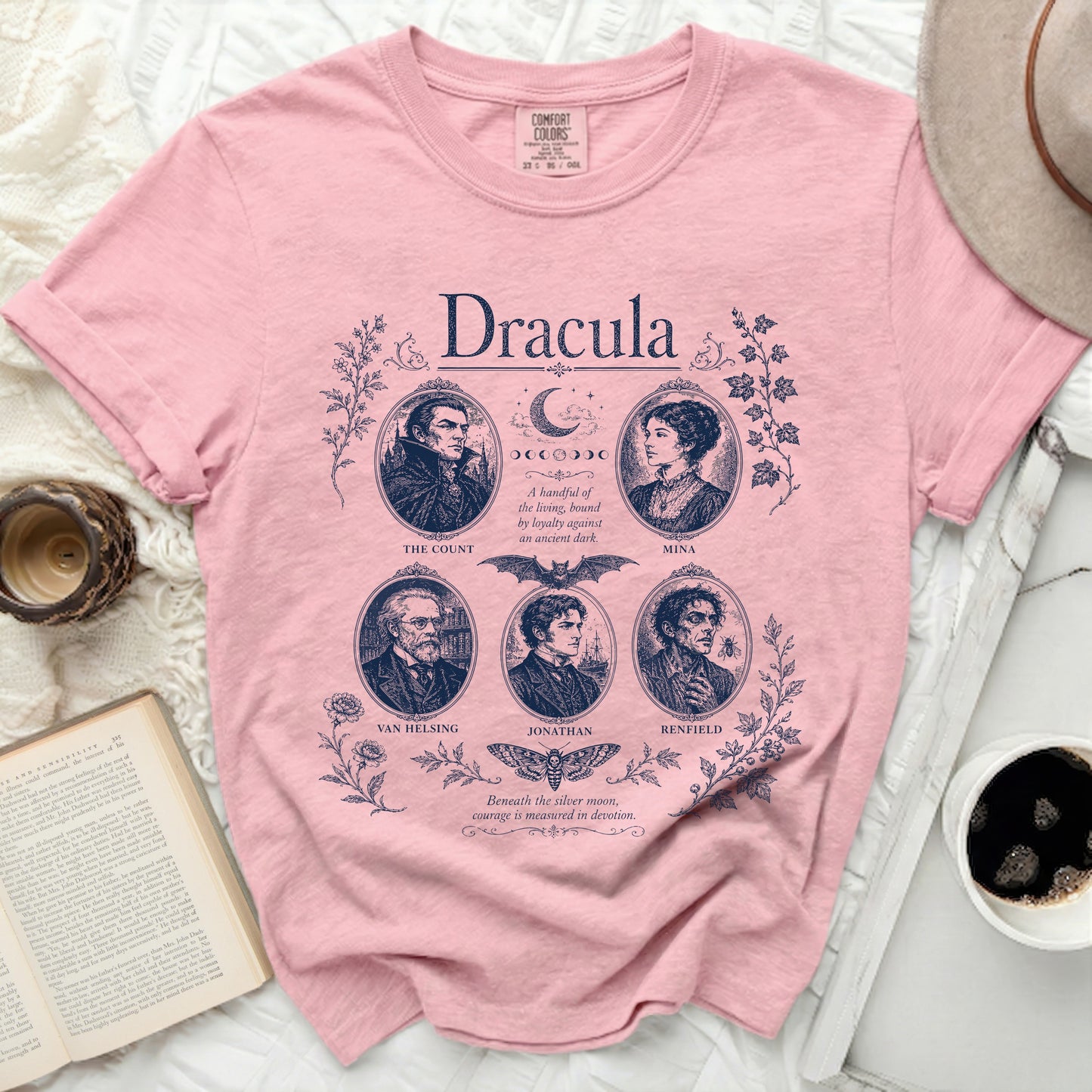 Pink Comfort Colors t-shirt with Dracula character portraits and text.