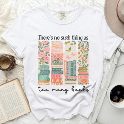 White t-shirt with stacked books and floral illustration, "There's no such thing as too many books" text.