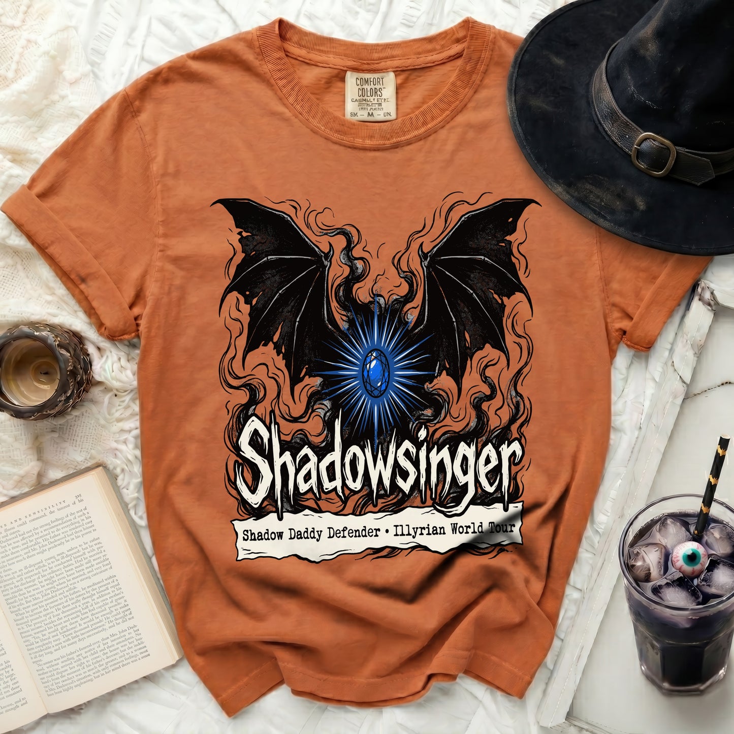 Orange t-shirt with "Shadowsinger" and bat wings graphic, "Shadow Daddy Defender" tour text.