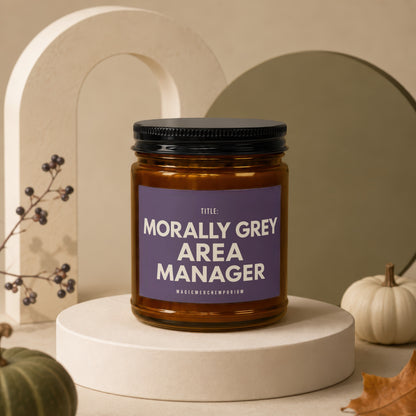 Amber jar candle with black lid, reads "Morally Grey Area Manager" and "MagicMerchEmporium".