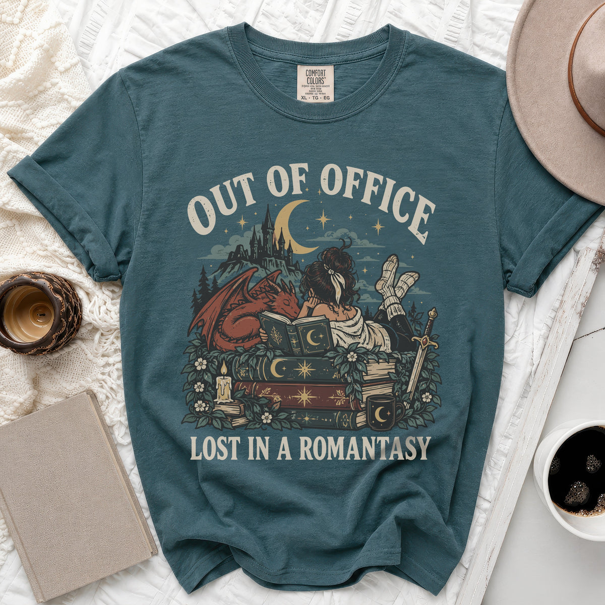 Teal t-shirt with "Out of Office Lost in a Romantasy" graphic featuring dragon, castle, and books.