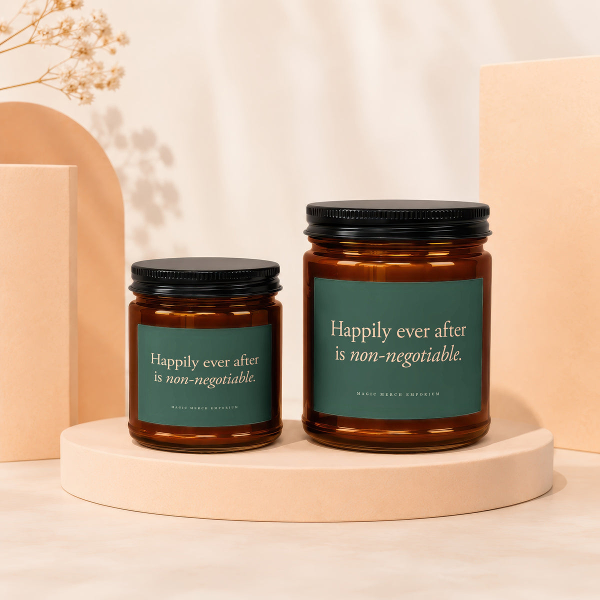 Two amber glass candles with dark lids, featuring text "Happily ever after is non-negotiable."
