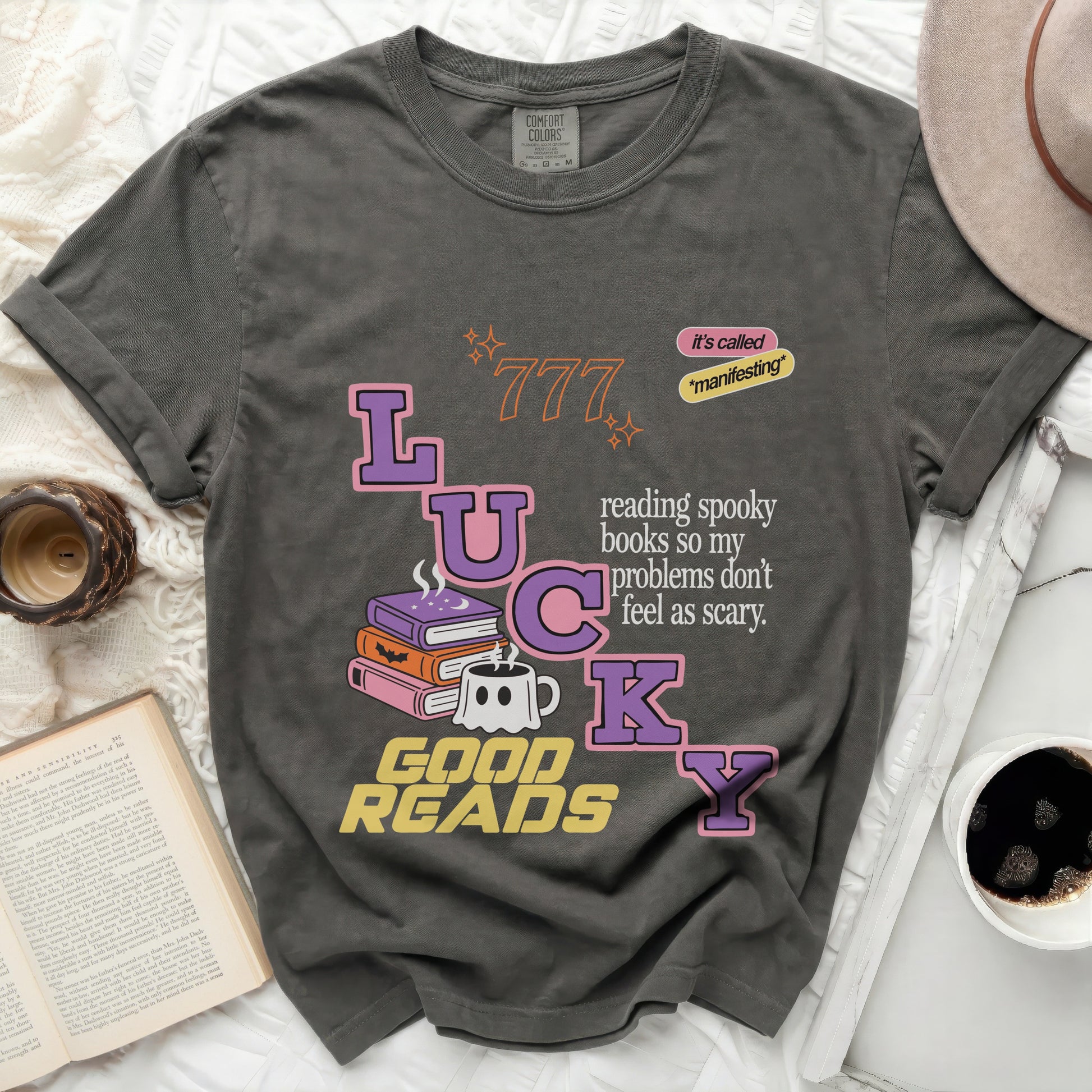 Graphic tee with "LUCKY GOOD READS" and spooky book graphics.