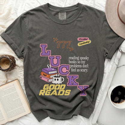 Graphic tee with "LUCKY GOOD READS" and spooky book graphics.