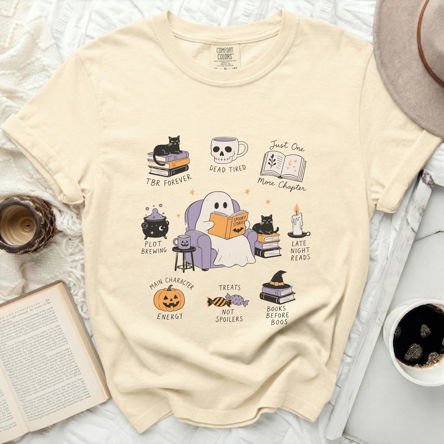 Cream t-shirt with Halloween-themed book lover illustrations and text.