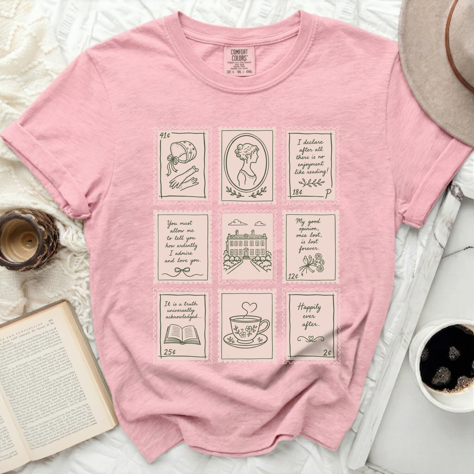 Pink t-shirt with nine postage stamp illustrations of historical scenes and quotes.
