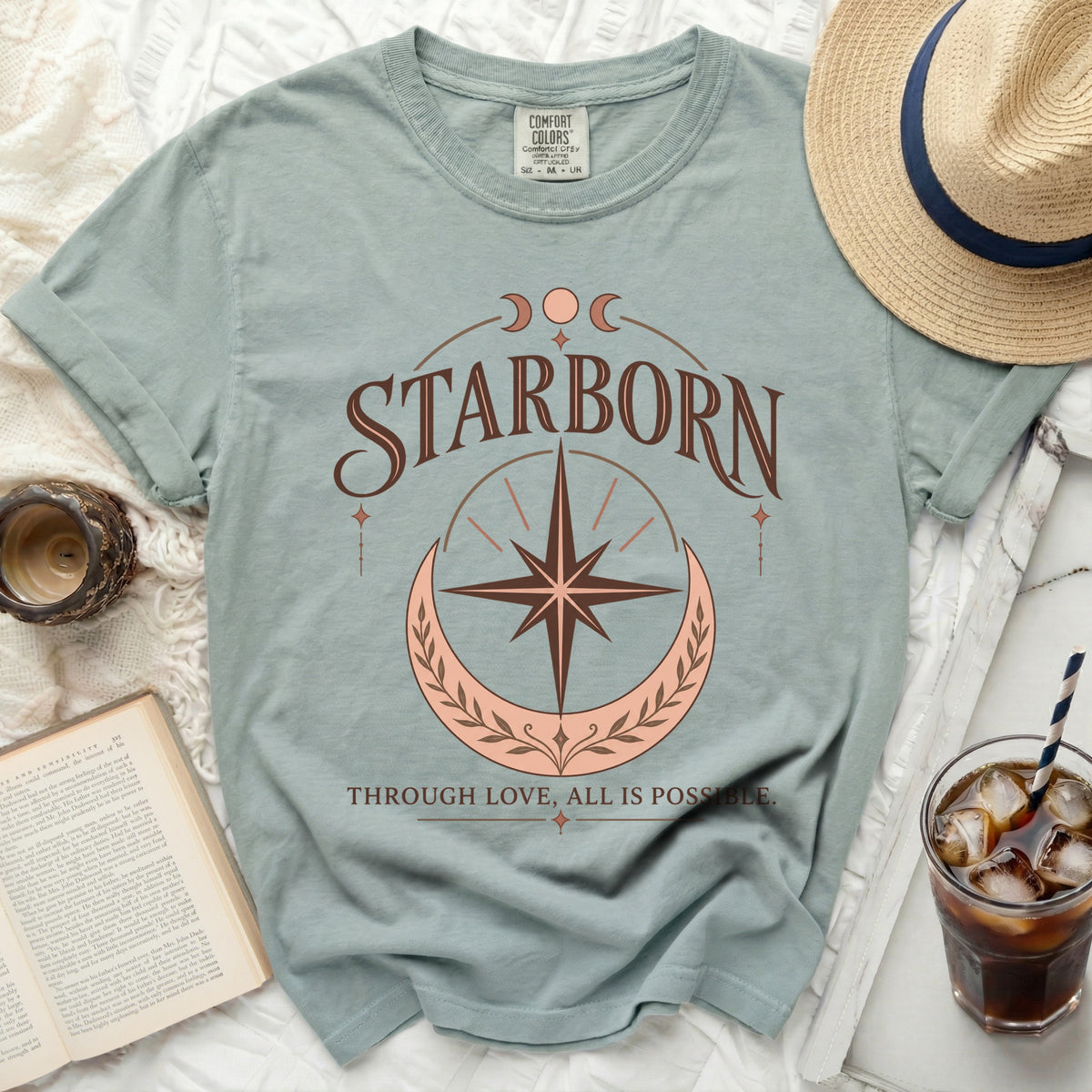 Blue t-shirt with "STARBORN" and "THROUGH LOVE, ALL IS POSSIBLE." text.