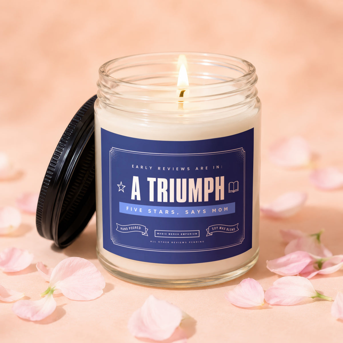 Lit glass candle with "A Triumph" label, surrounded by pink petals.