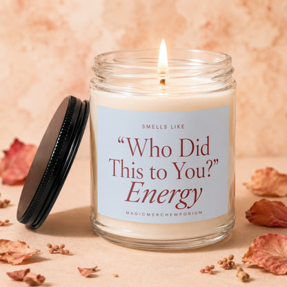 Lit candle in glass jar with label: "Smells Like 'Who Did This to You?' Energy."