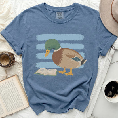 Mallard duck reading a book on blue stripes with Comfort Colors tag.