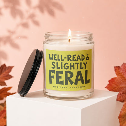 Jar candle with lit wick, labeled "Well-Read & Slightly Feral".