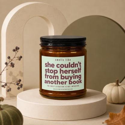 Candle with text "she couldn't stop herself from buying another book".