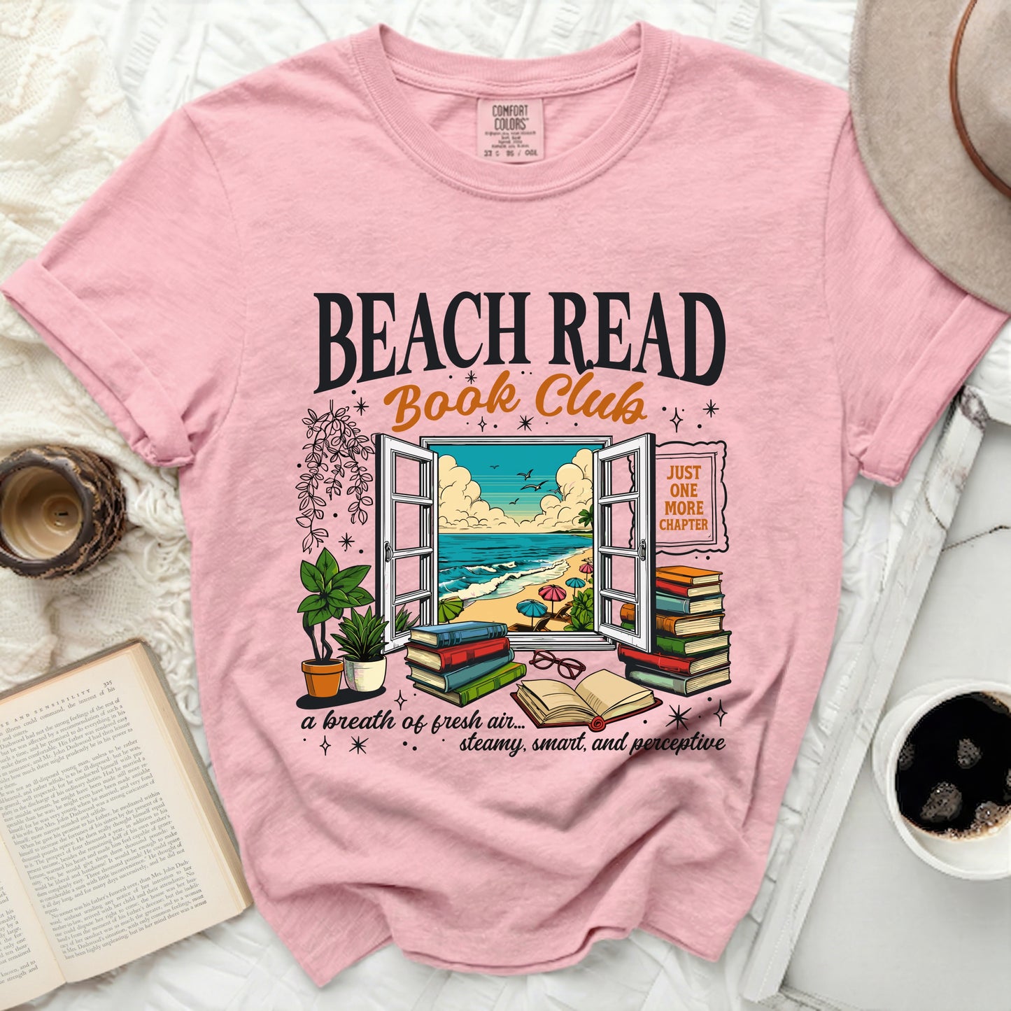 Pink t-shirt with "Beach Read Book Club" and beach scene graphic.