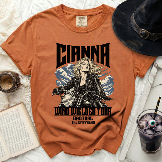 Orange t-shirt with "Cianna" graphic of a woman on a motorcycle, "Wind Wielder Tour" and "Gaothal The Empyrean".