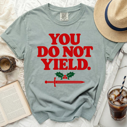 T-shirt with red text "YOU DO NOT YIELD" and a sword with holly.