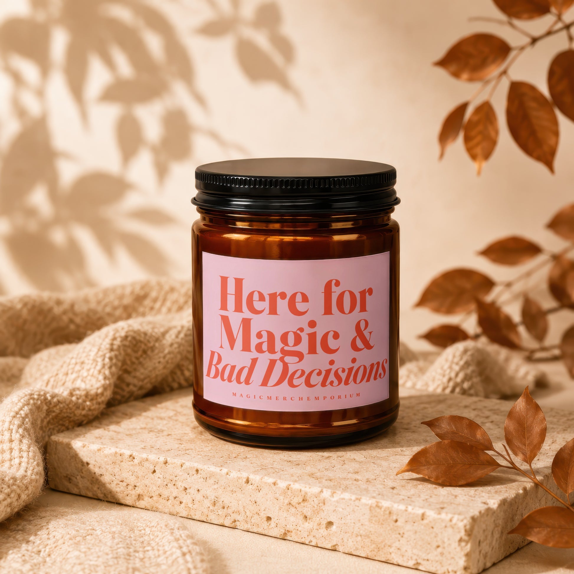 Brown candle with pink label that reads "Here for Magic & Bad Decisions".