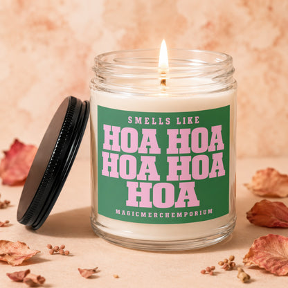 Scented candle with "Smells Like Hoa Hoa Hoa" text on green label.