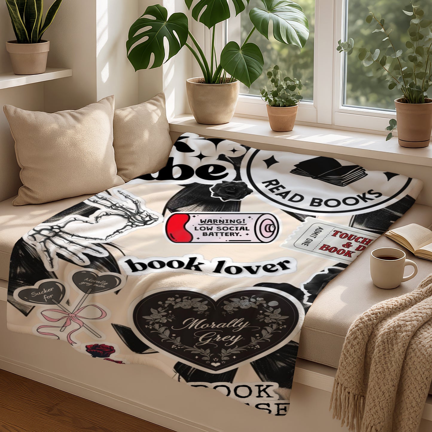Blanket with bookish stickers including "book lover," "read books," and a low battery icon.
