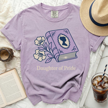 Lavender shirt with "Daughter of Pride" and book graphic.